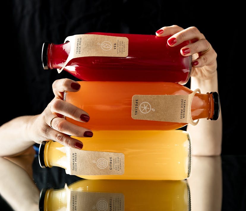 Three Tasmanian Juice Press bottles of juice stacked on each-other.