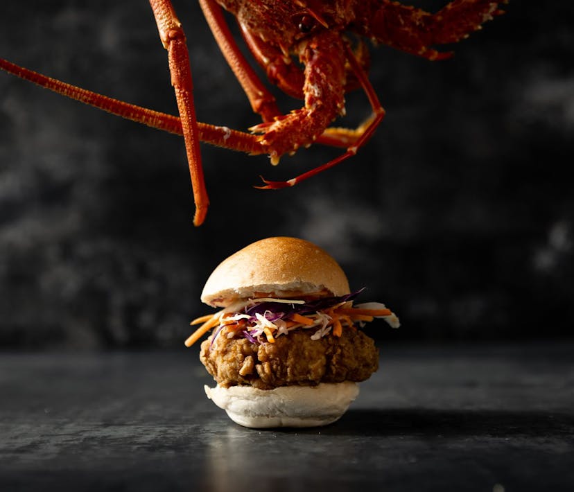 A Krispy Fried Cray Slider, dangling above is a crayfish.
