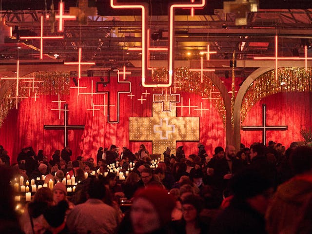 Hundreds of people seated, and walking around inside PW1 at Dark Mofo's Winter Feast.
