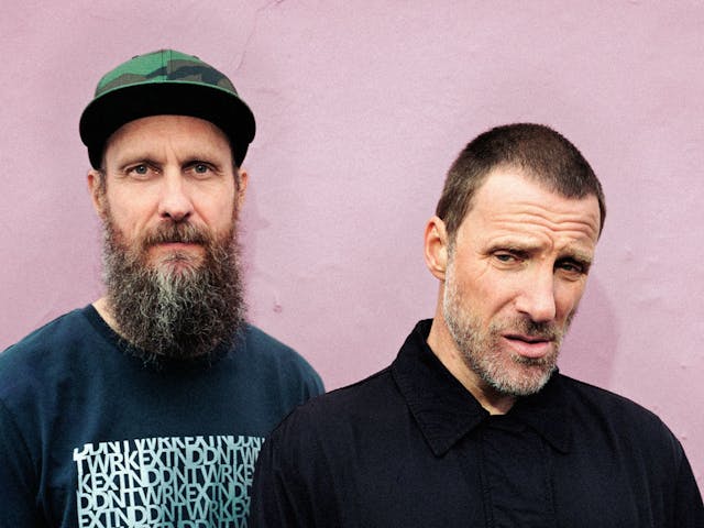 The two members of Sleaford Mods pose for a portrait shot.