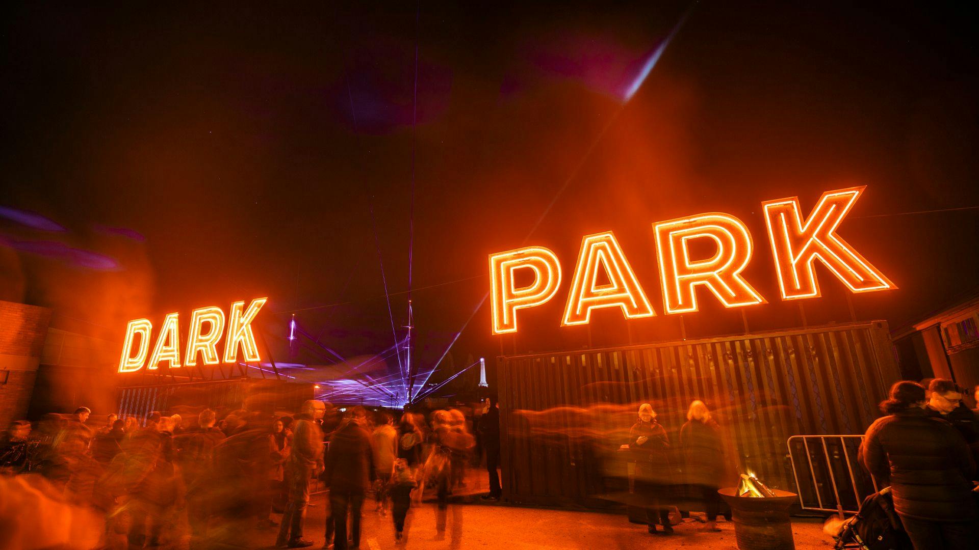 Dark Park entry signage, huge neon red letters.